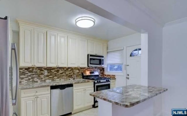 kitchen featuring light stone countertops, appliances with stainless steel finishes, tasteful backsplash, and crown molding