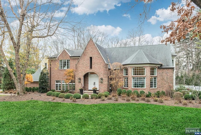 tudor-style house with a front yard