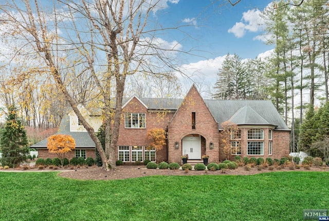 tudor home with a front yard