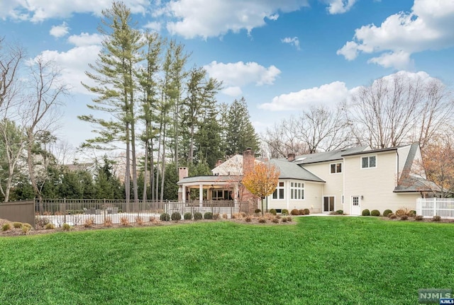 back of house with a lawn