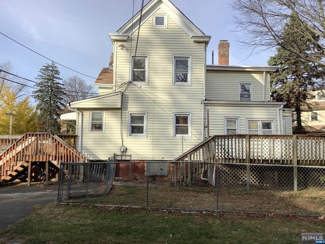 back of house with a wooden deck