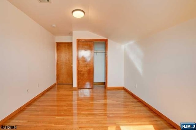 bonus room with light hardwood / wood-style flooring and vaulted ceiling