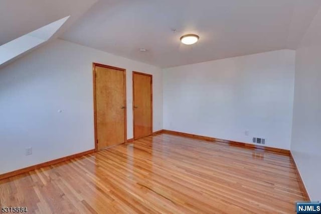 bonus room with light wood-type flooring