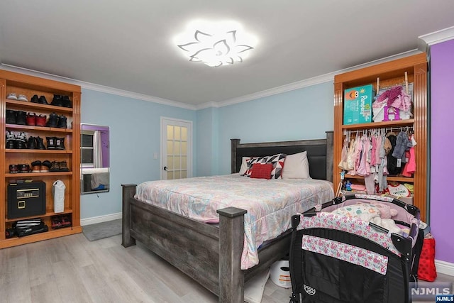 bedroom featuring light wood-type flooring and ornamental molding