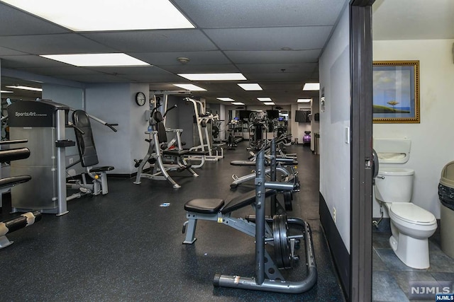 exercise room featuring a drop ceiling