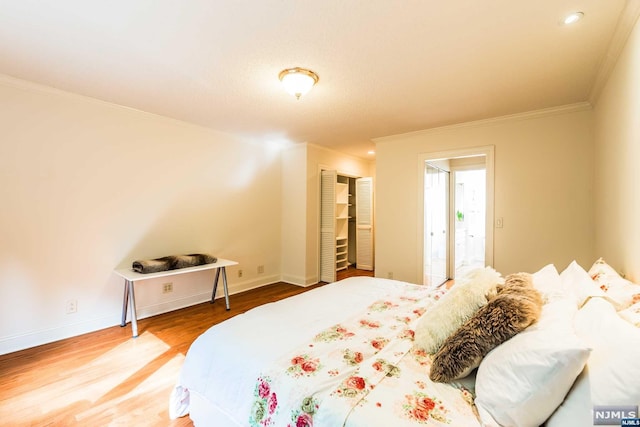 bedroom with hardwood / wood-style floors and crown molding