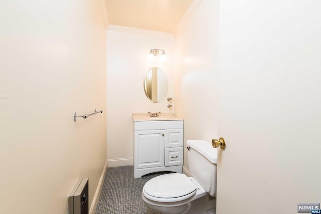 bathroom featuring tile patterned floors, vanity, toilet, and ornamental molding