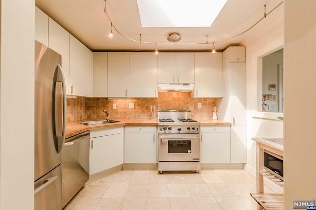 kitchen with sink, white cabinetry, and stainless steel appliances