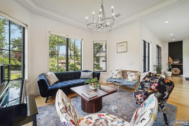 living room with wood-type flooring and an inviting chandelier