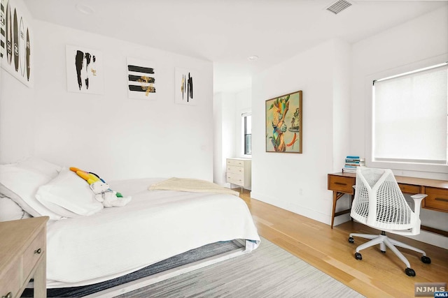 bedroom with light wood-type flooring