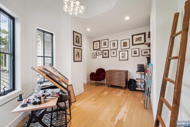 office space featuring a chandelier and light wood-type flooring