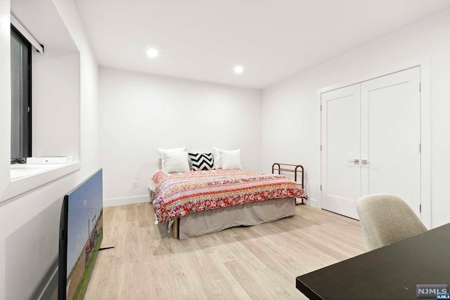 bedroom featuring light hardwood / wood-style floors and a closet