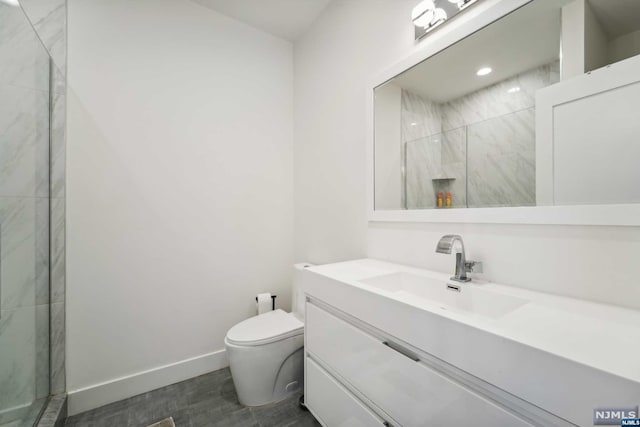 bathroom with vanity, toilet, and walk in shower