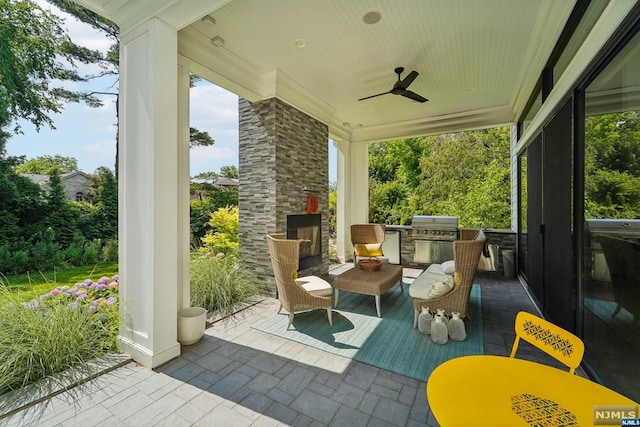 view of patio featuring a grill, ceiling fan, and exterior kitchen