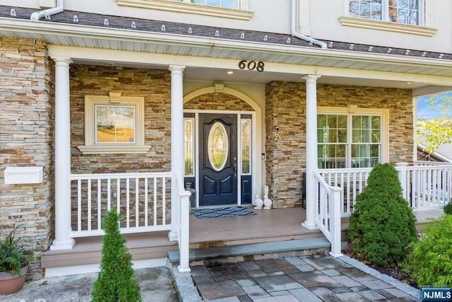 entrance to property featuring covered porch