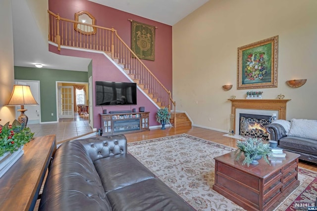 living room featuring hardwood / wood-style floors and a towering ceiling