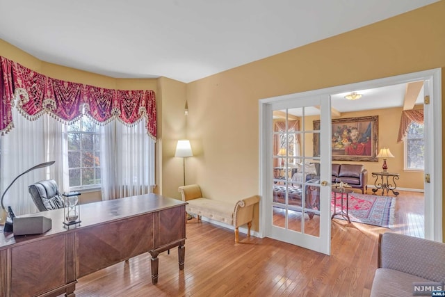 home office featuring french doors and hardwood / wood-style flooring