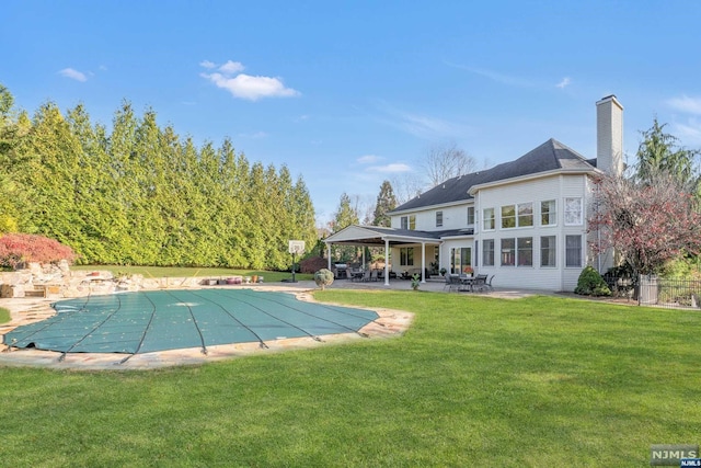 view of swimming pool featuring a yard and a patio area