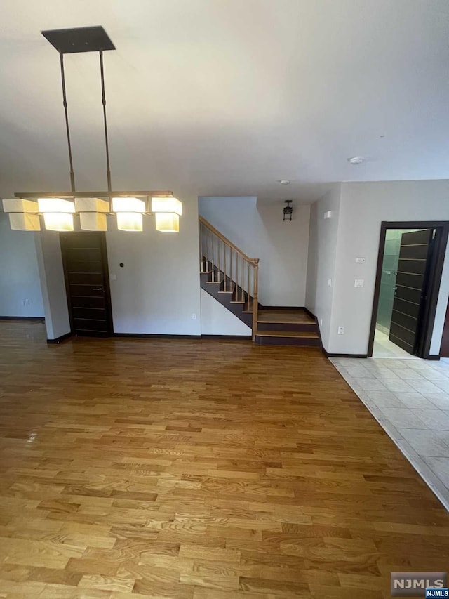 unfurnished living room featuring light hardwood / wood-style floors