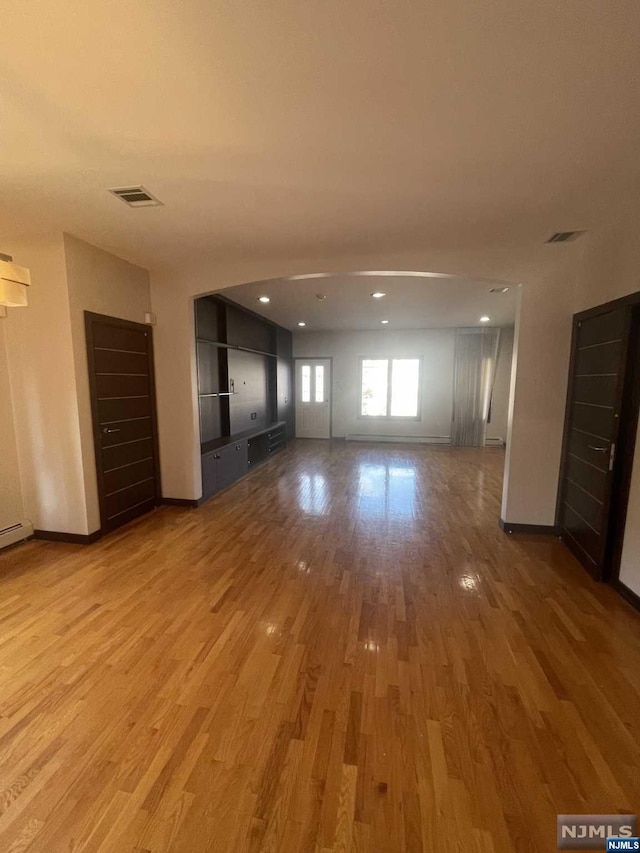 unfurnished living room with hardwood / wood-style flooring