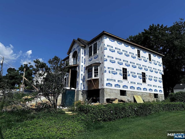 view of side of home featuring a yard