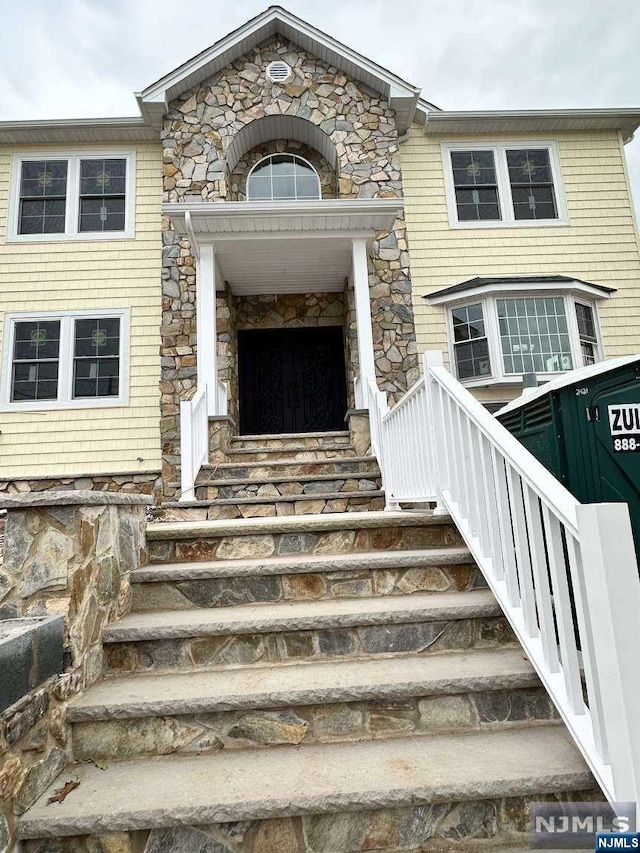 entrance to property featuring stone siding