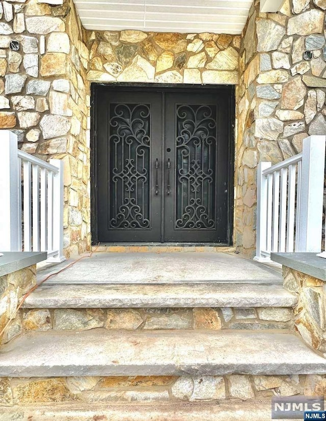 view of exterior entry with stone siding