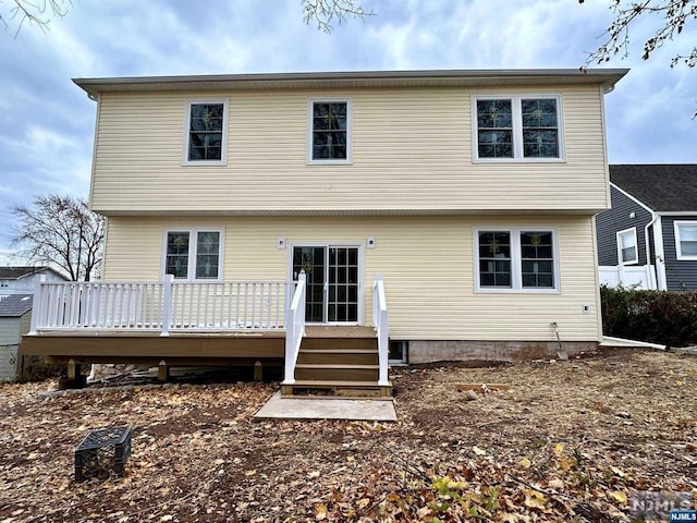 rear view of house with a wooden deck