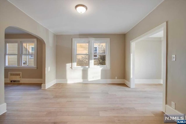 interior space featuring radiator and light hardwood / wood-style flooring