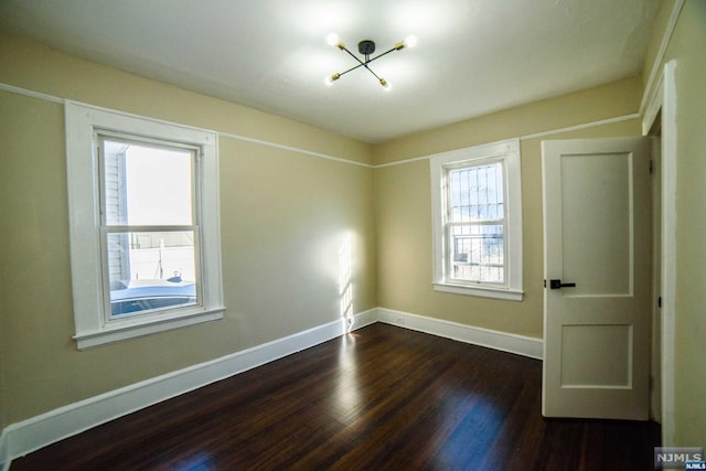 empty room featuring dark hardwood / wood-style flooring