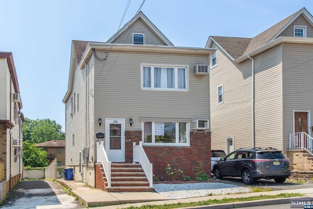 view of front of home with a wall mounted AC