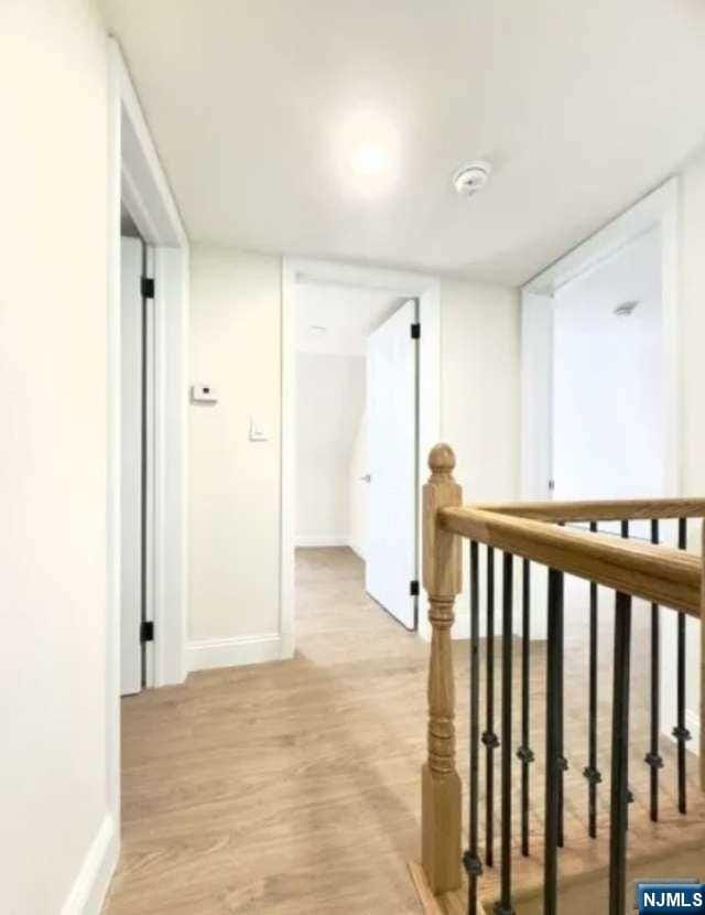 corridor with light hardwood / wood-style flooring