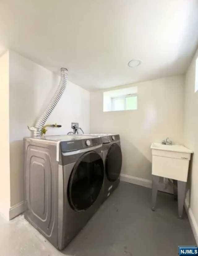 laundry room with washing machine and clothes dryer