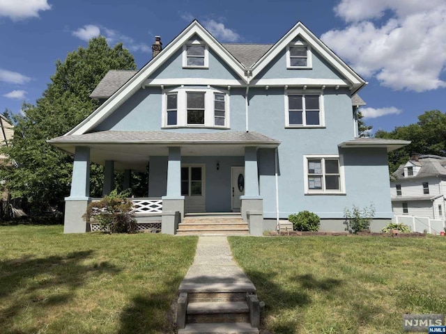 victorian house with a porch and a front yard