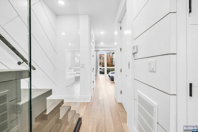 corridor with light hardwood / wood-style floors