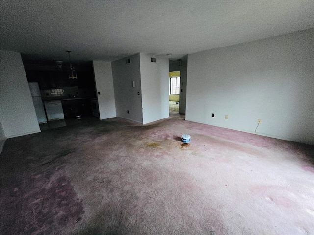 unfurnished living room with carpet flooring