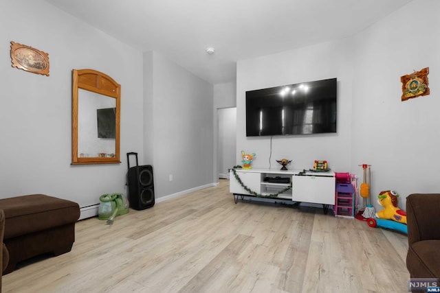 living room featuring a baseboard radiator and light hardwood / wood-style flooring