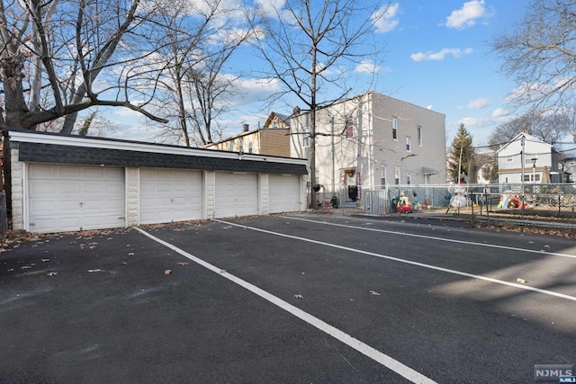 view of parking / parking lot featuring a garage