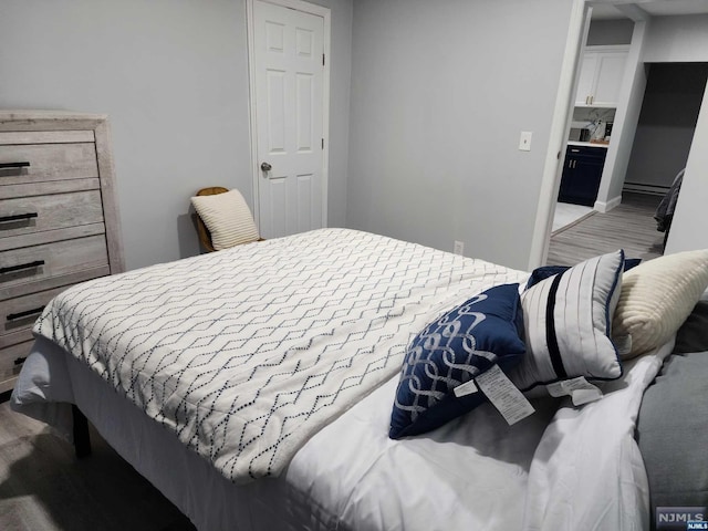 bedroom with hardwood / wood-style flooring