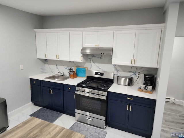 kitchen with blue cabinets, sink, gas range, tasteful backsplash, and white cabinetry