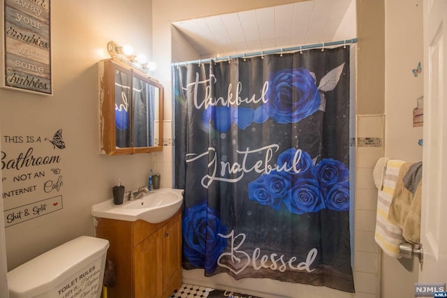 bathroom featuring vanity, toilet, and walk in shower