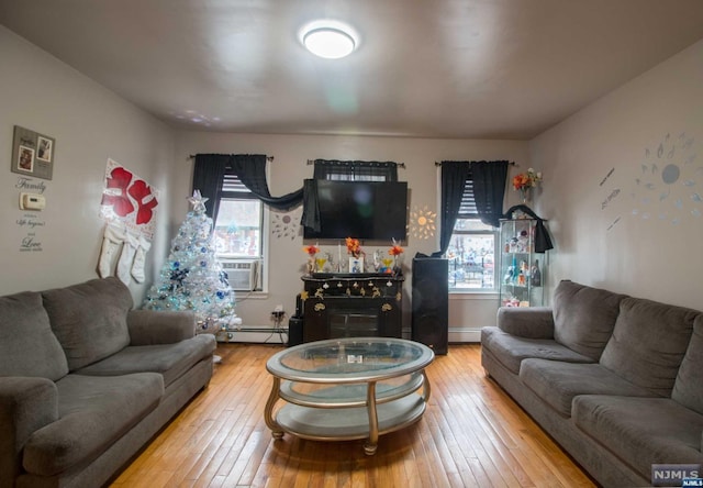 living room with hardwood / wood-style floors, plenty of natural light, and cooling unit