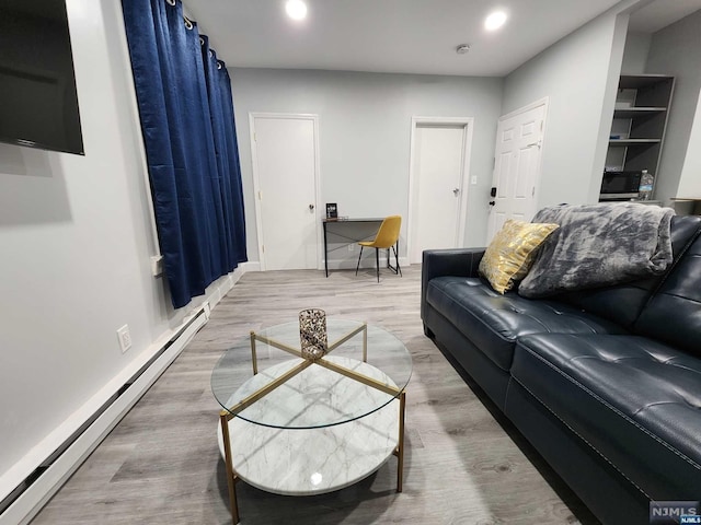 living room with wood-type flooring and baseboard heating