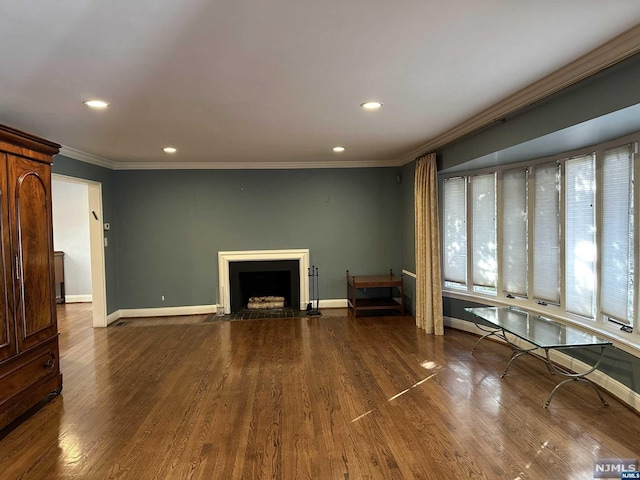 unfurnished living room featuring crown molding and hardwood / wood-style flooring