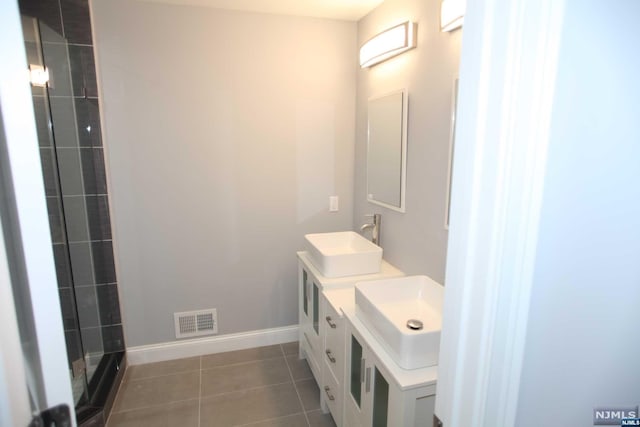 bathroom featuring tile patterned flooring and vanity