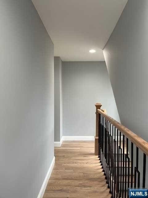 stairway with hardwood / wood-style flooring