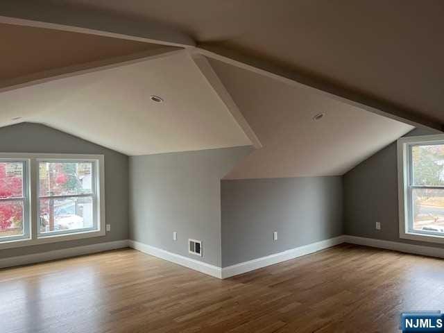 bonus room featuring hardwood / wood-style floors and lofted ceiling