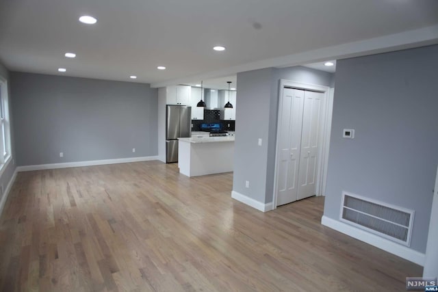 unfurnished living room with light hardwood / wood-style flooring