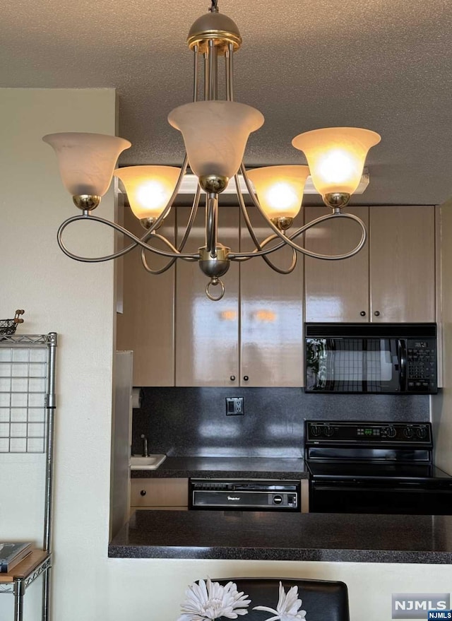 kitchen featuring sink, black appliances, a textured ceiling, and an inviting chandelier