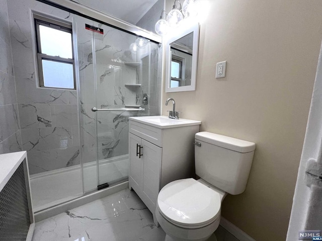 bathroom featuring vanity, toilet, and a shower with shower door